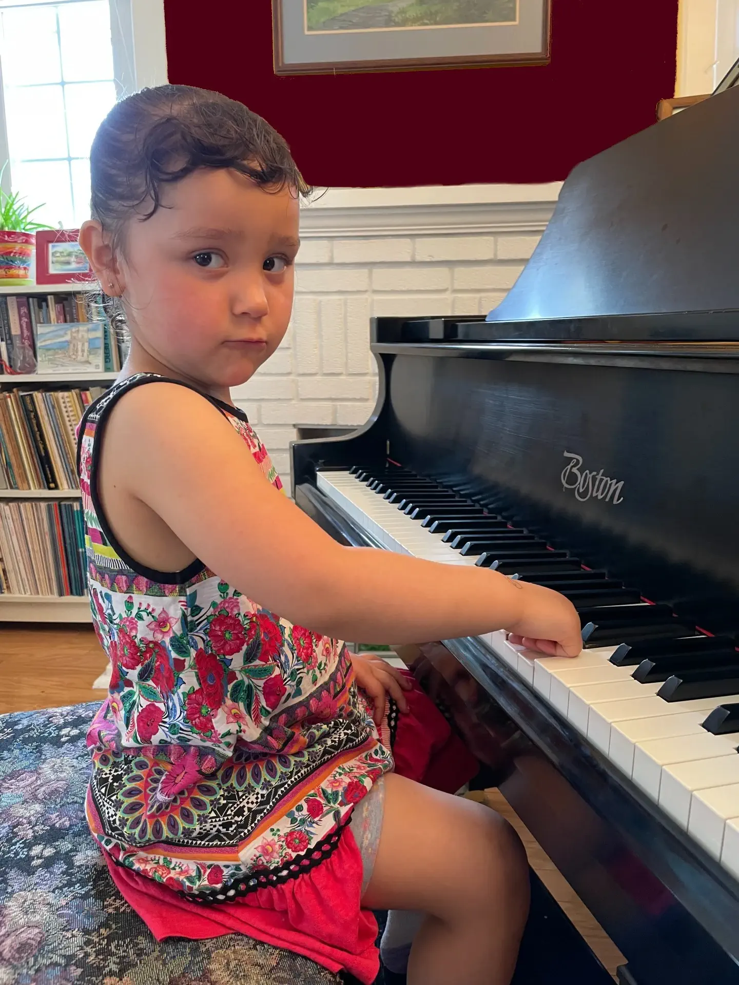 little girl sitting at a piano